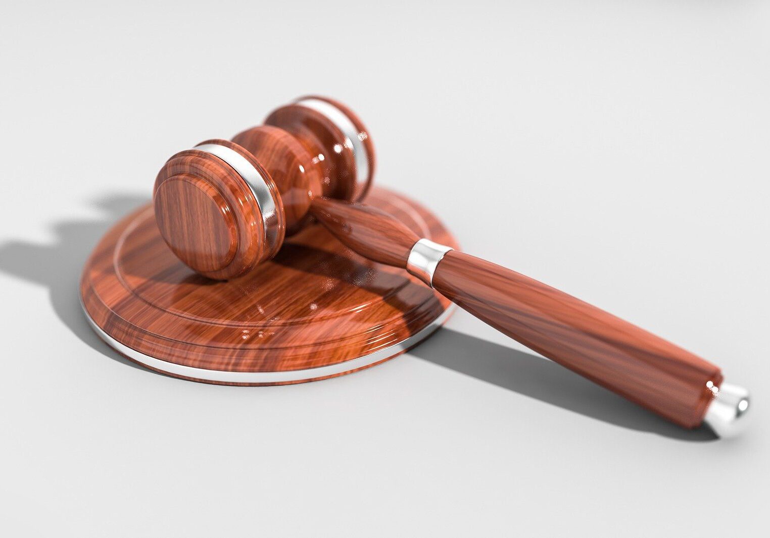 A wooden gavel sitting on top of a brown object.